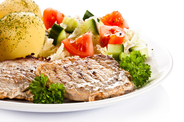 Fried steaks, boiled potatoes and vegetable salad