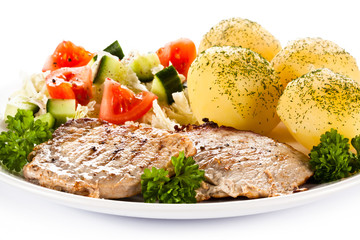 Fried steaks, boiled potatoes and vegetable salad