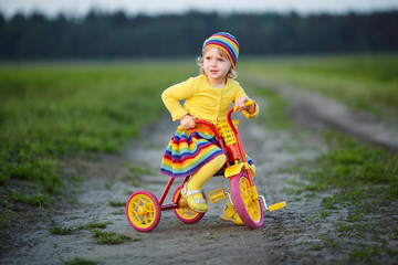 girl with colorful dress on the bicycle