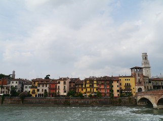 Fototapeta na wymiar Colorful houses along the Adige river in Verona