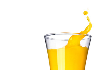 Splashing orange juice in glass on white background