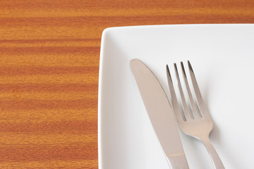 White place setting on wooden table
