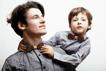 father with son in bowties on white background, casual look