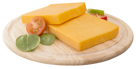 two slices of cheddar on wooden board decorated with cherry and