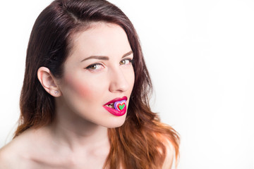 sexy girl with candy heart shape in her mouth