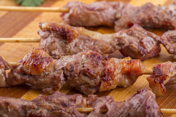 Lamb Skewers on Wooden Plate