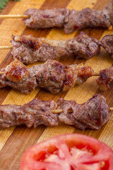 Lamb Skewers on Wooden Plate