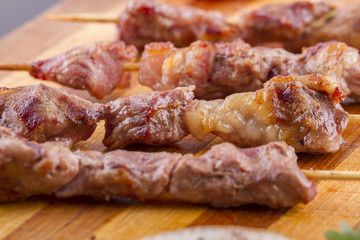 Lamb Skewers on Wooden Plate