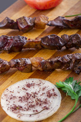 Grilled Liver Kebab on a Wood Plate