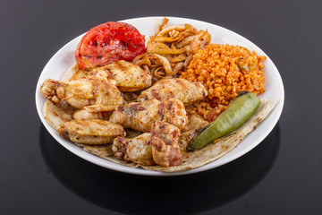 grilled chicken wings and legs on wooden plate
