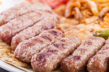 Grilled meatballs on a white plate