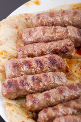Grilled meatballs on a white plate