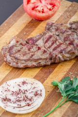 Grilled Steaks and Vegetables On a Wood Plate