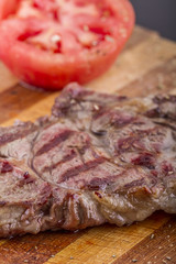 Grilled Steaks and Vegetables On a Wood Plate