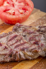 Grilled Steaks and Vegetables On a Wood Plate