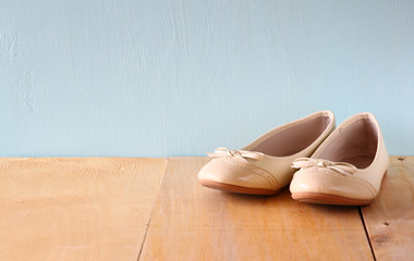 girl shoes over wooden deck floor