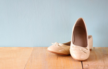 girl shoes over wooden deck floor