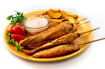 The chicken kebab on skewers with vegetables