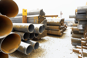 many steel pipes on outdoor warehouse