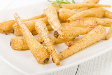 Parsnips - Honey roasted parsnips on a white background