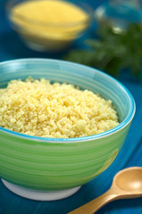 Cooked couscous in colorful bowl