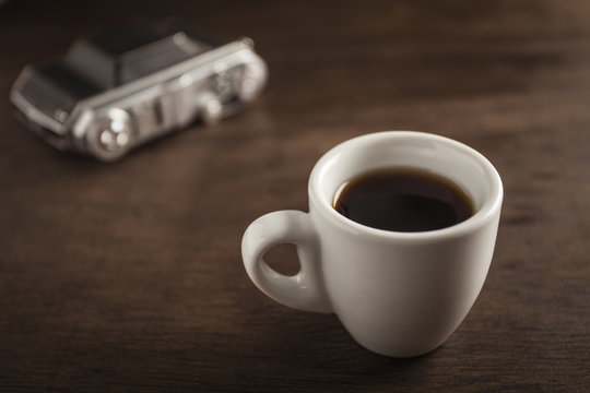 Old camera and coffee cup