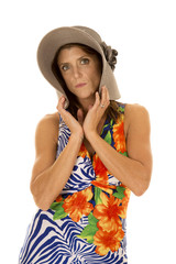 woman in hawaiin dress fold hat over face