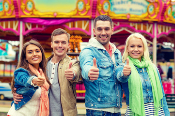Naklejka premium group of smiling friends showing thumbs up