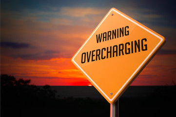 Overcharging on Warning Road Sign.