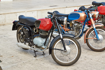 Old scooter parked on the square in city Senigali