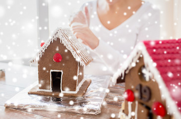 close up of woman making gingerbread houses