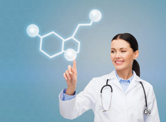 smiling female doctor pointing to molecule