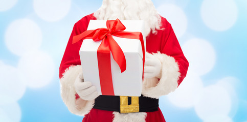 close up of santa claus with gift box