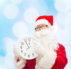 man in costume of santa claus with clock