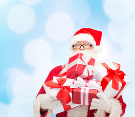 man in costume of santa claus with gift boxes
