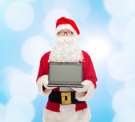 man in costume of santa claus with laptop