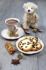 Christmas composition: cup of coffee, biscuits and a teddy bear