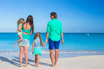 Family of four with two kids during beach vacation