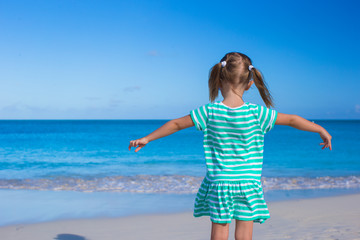 Adorable little girl at white beach during summer vacation