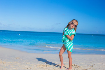 Adorable little girl at white beach during summer vacation