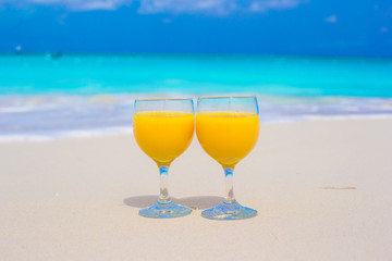 Closeup of two glasses on tropical white beach