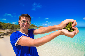 Happy young man making heart with hands