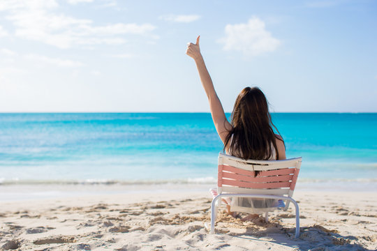 Young woman in beach chair during her tropical vacation