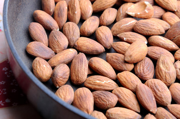roasted almonds on wooden background