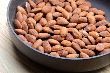 roasted almonds on wooden background