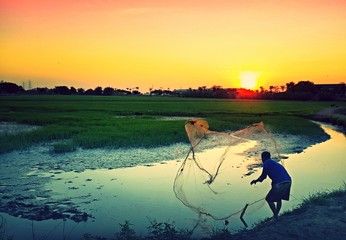 Local life in evening time (a man is catching fish)