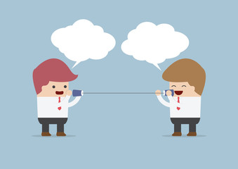 Businessmen talking on can phone