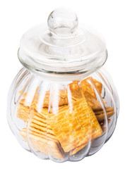 Sugar crackers or biscuits in a cookie jar over white background