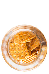Sugar crackers or biscuits in a cookie jar over white background