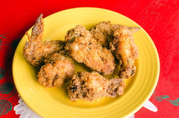 Fried chicken on a yellow plate